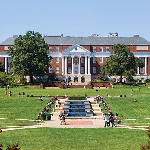 students walking and lounging on McKeldin Mall on a sunny day