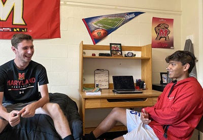 two students talking in residence hall room