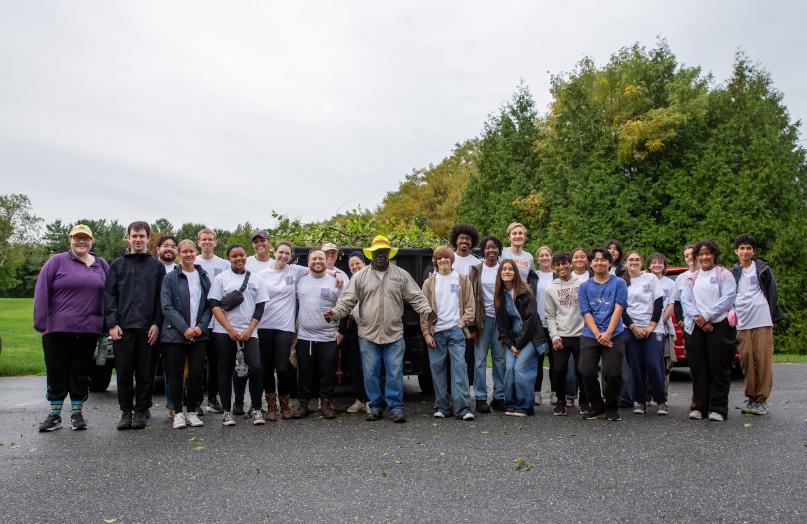 A group of student, faculty and staff volunteers after a reflective day on campus identifying and removing invasive plant species from wetlands on campus.