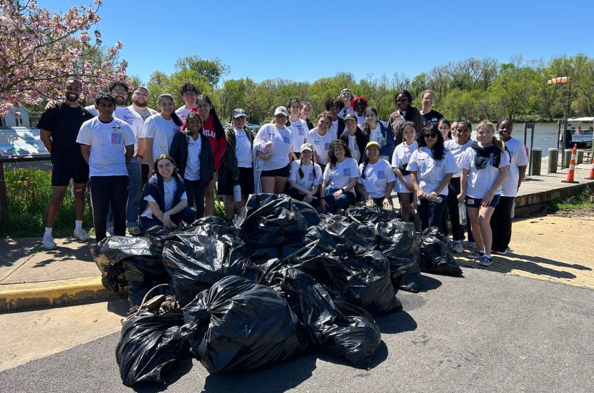 Students and staff volunteers cleanup of the Anacostia River during Restorative Service Day.