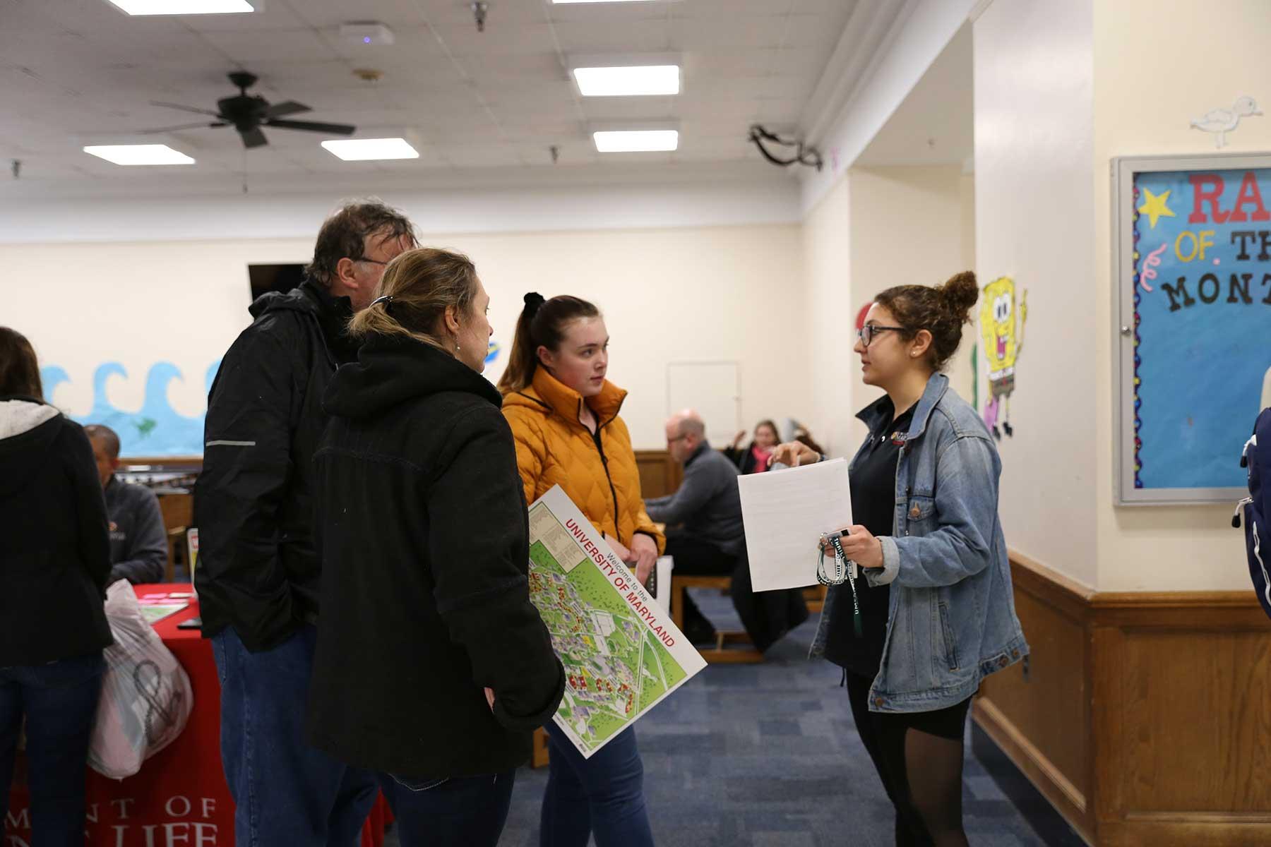 student with parents talking to a ResLife staff member