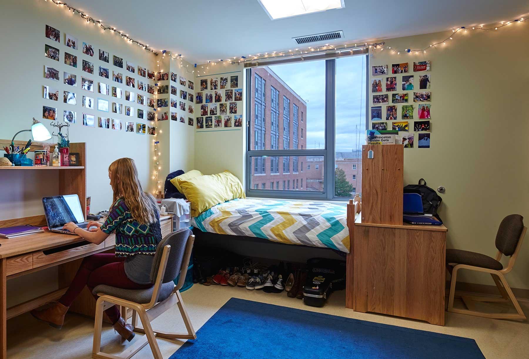 Student working at desk in dorm room