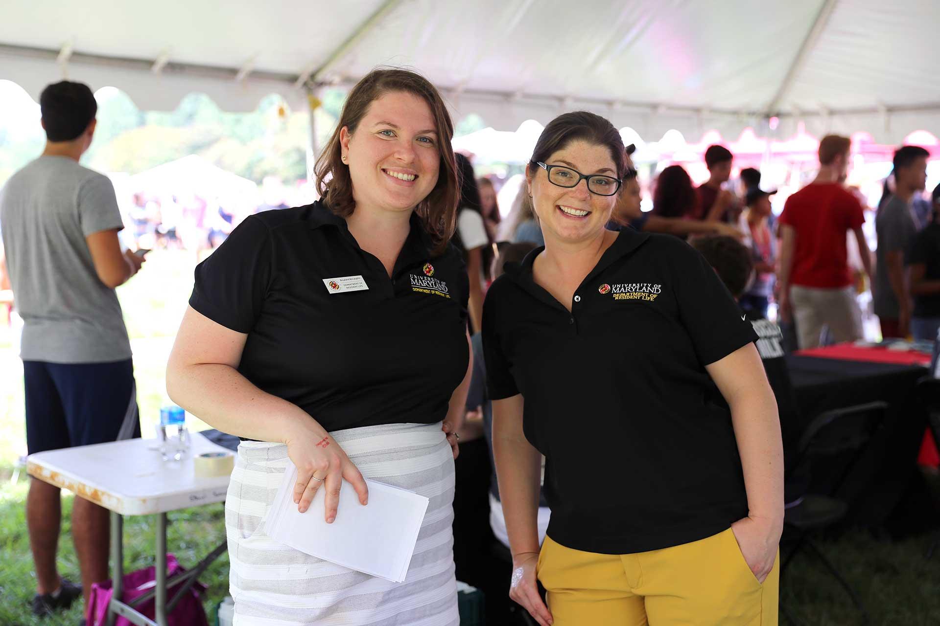 two resident life staff members in tent outside