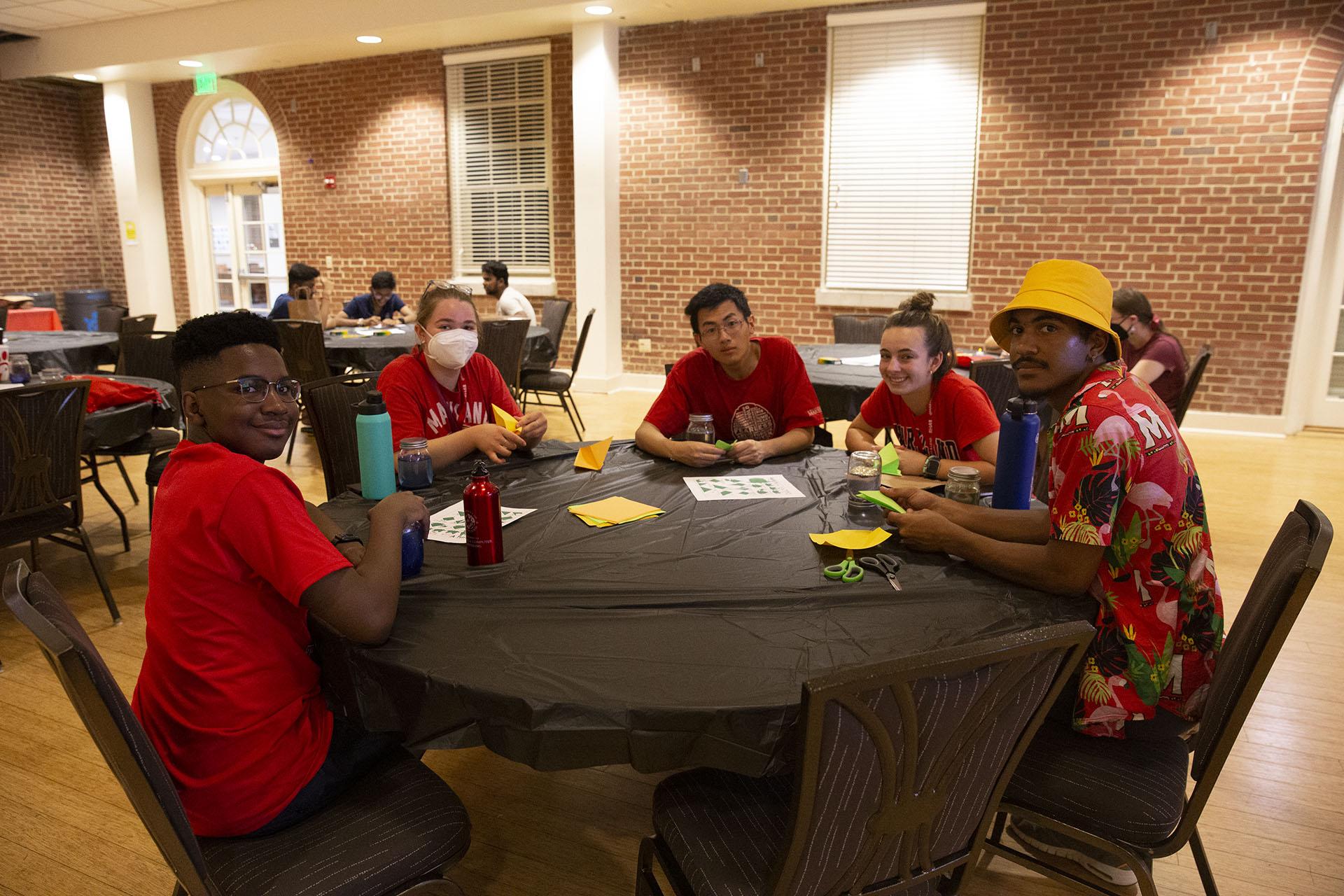 students at a table doing arts and crafts