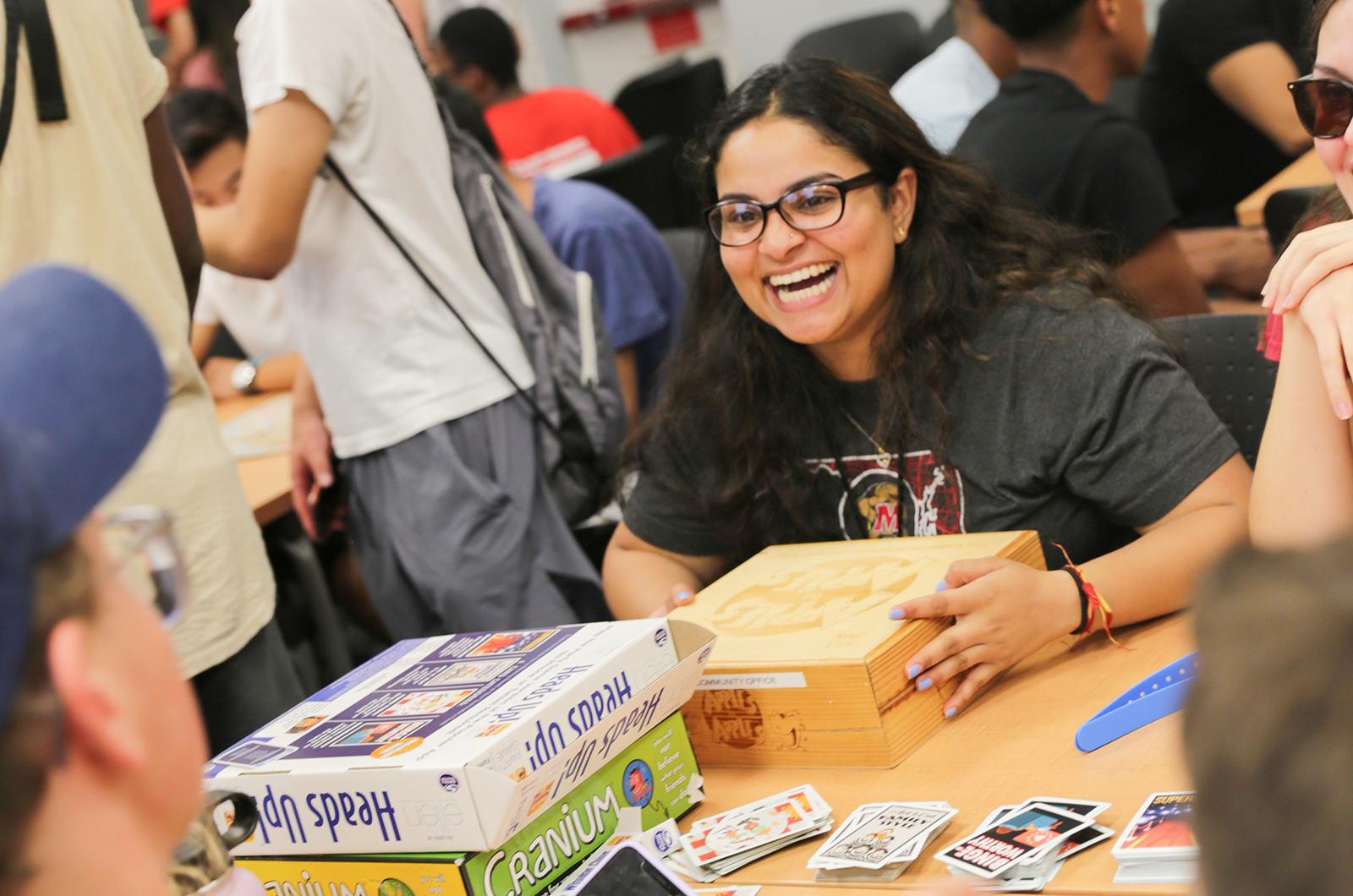 student laughing while playing a board game