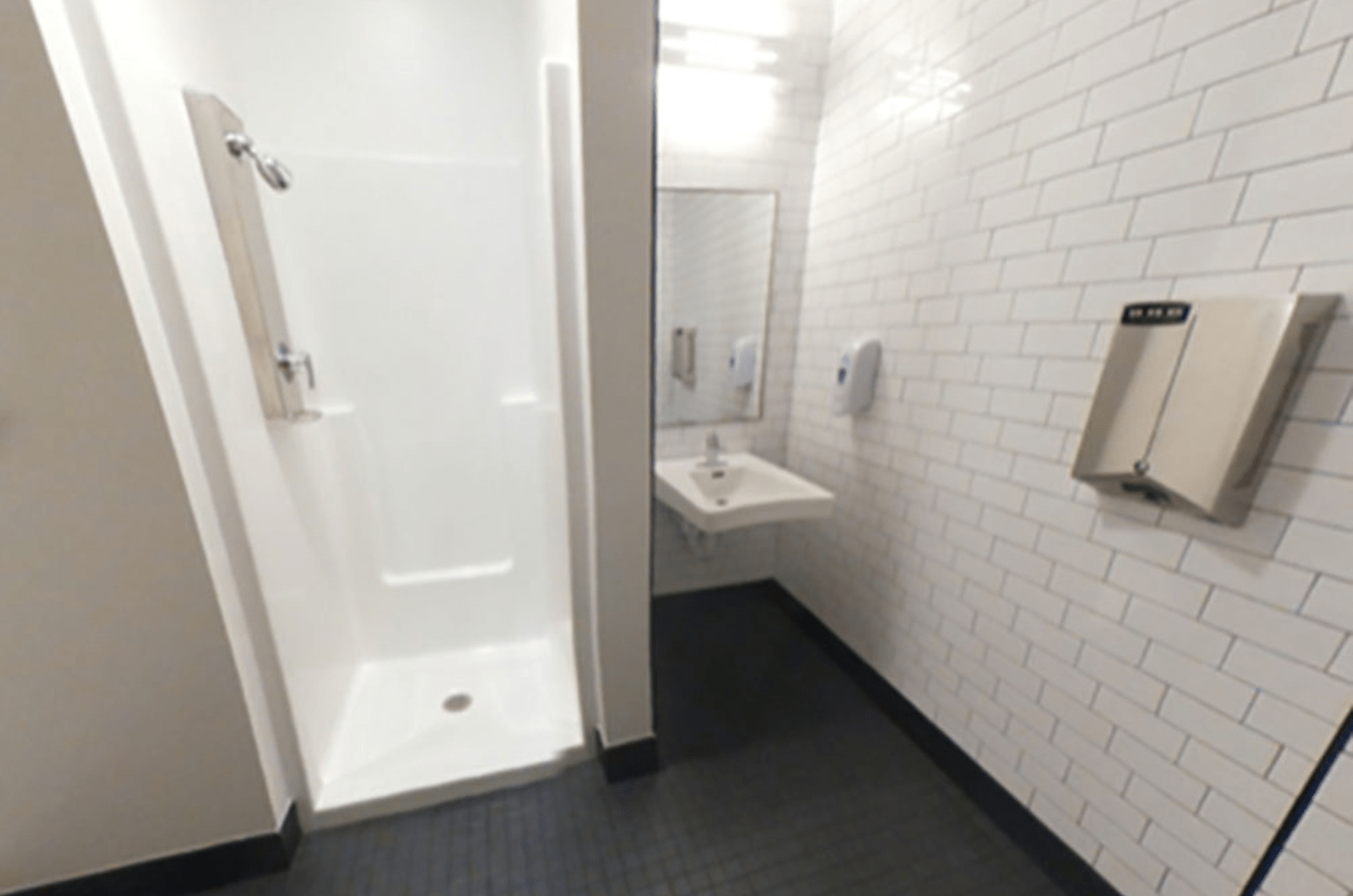 inside private bathroom with shower and sink visible