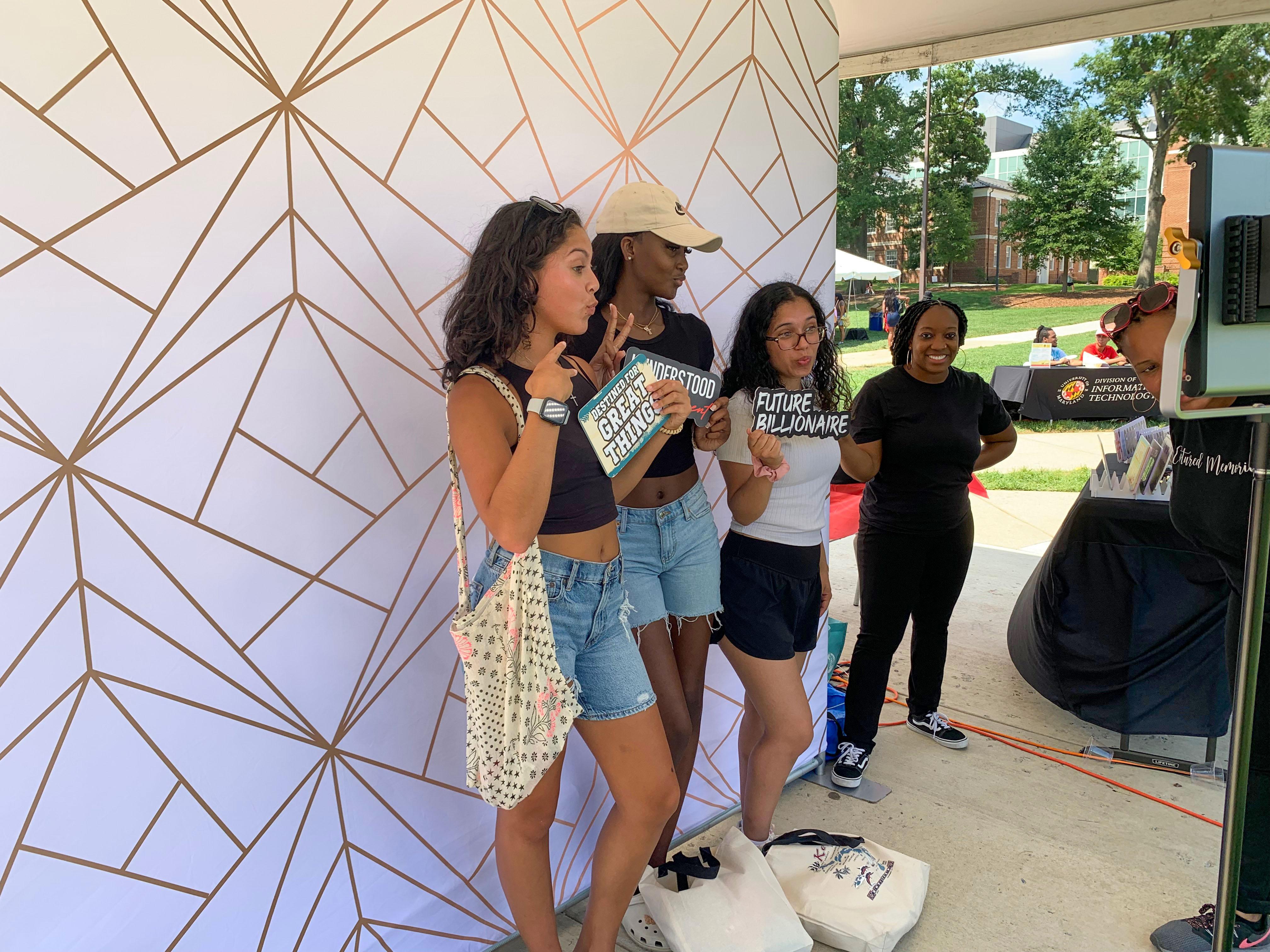 group of students posing at a photo booth during freefest