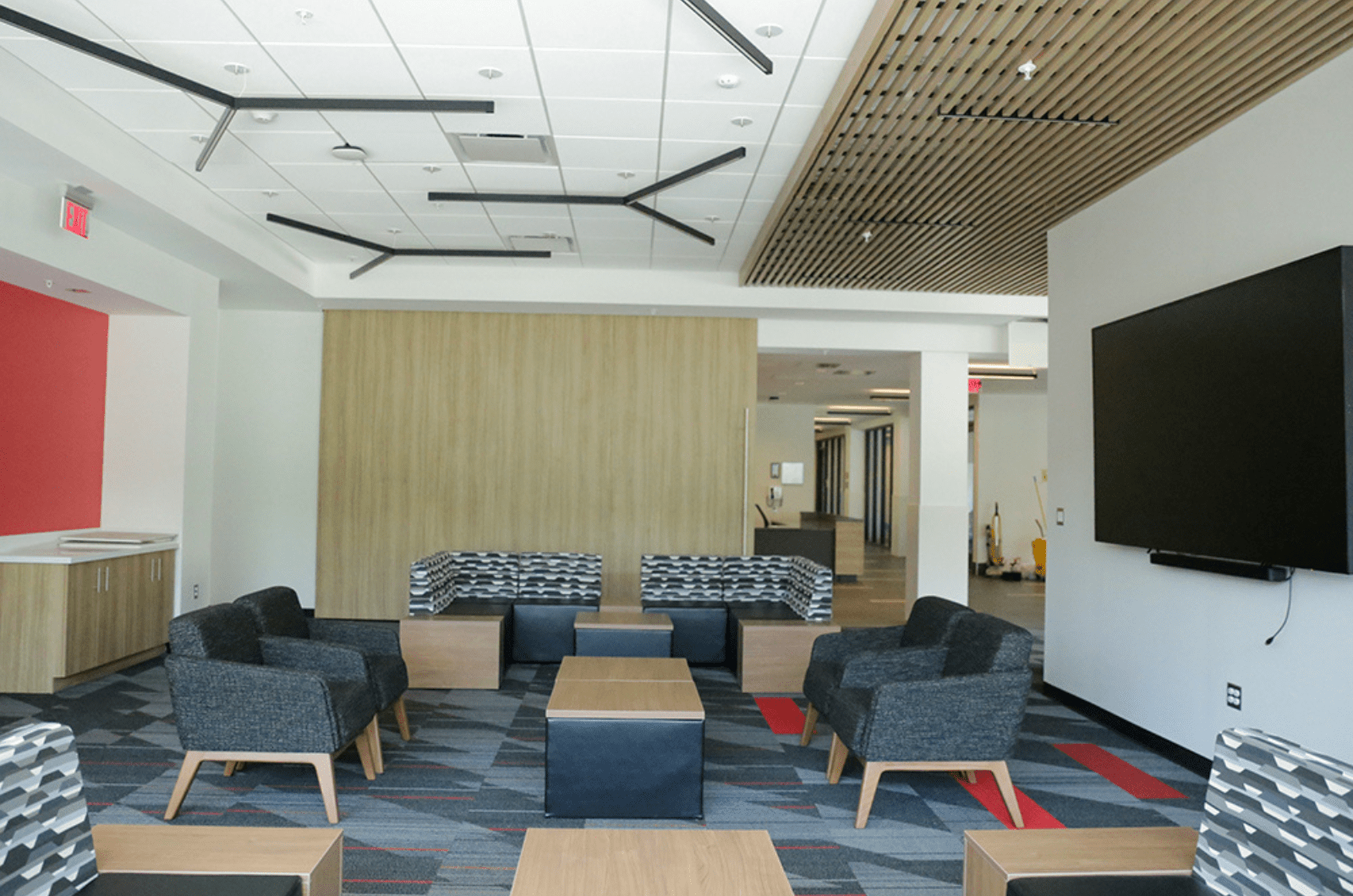 lounge area with single chairs, sofas, tables and TV on the first floor of Johnson-Whittle Hall