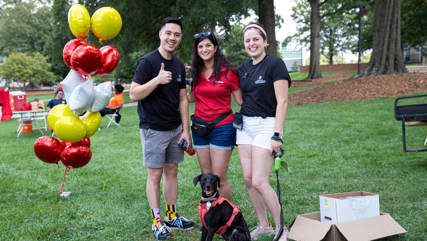 staff members with a dog at FreeFest