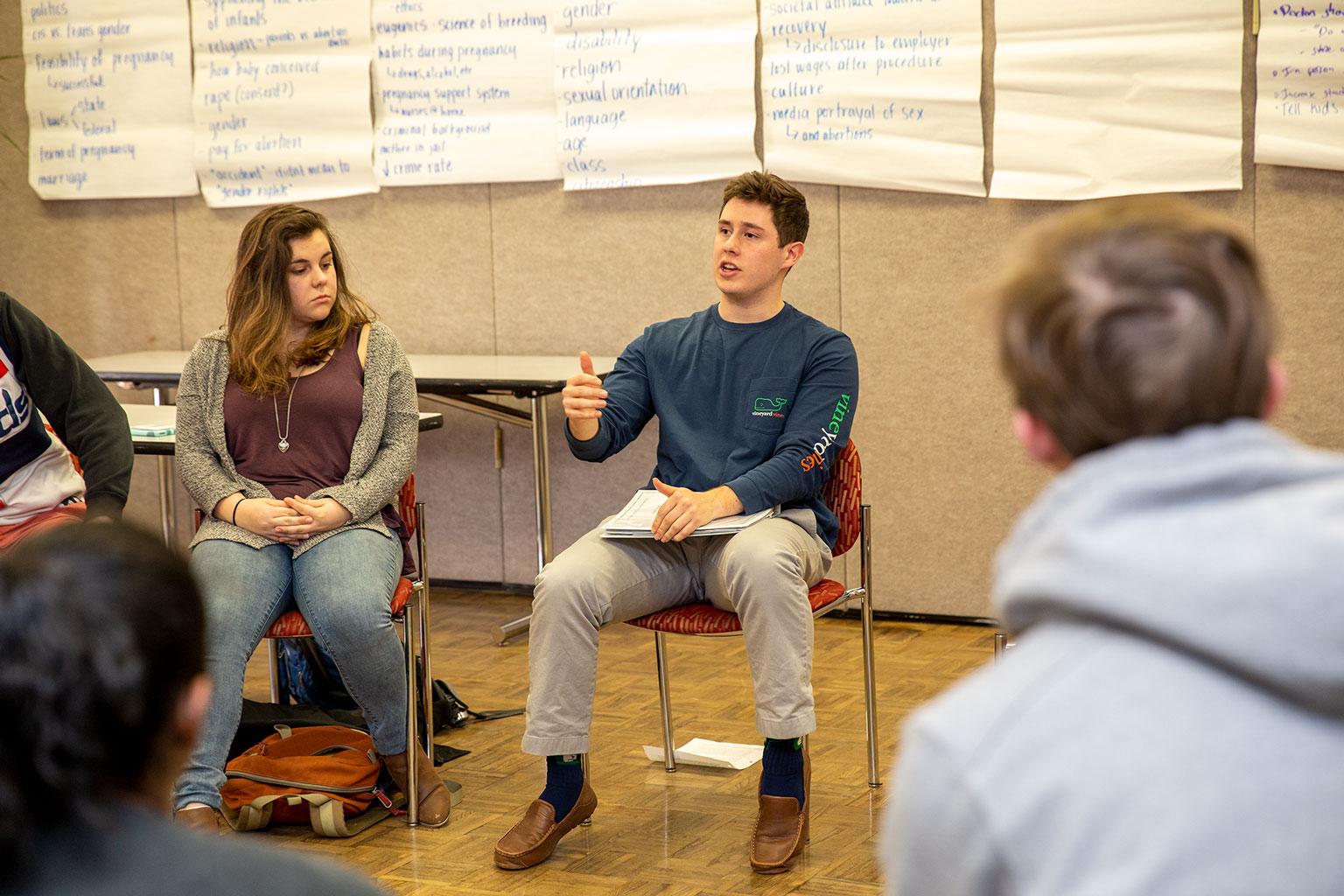 students sitting around in a circle and engaging in conversation