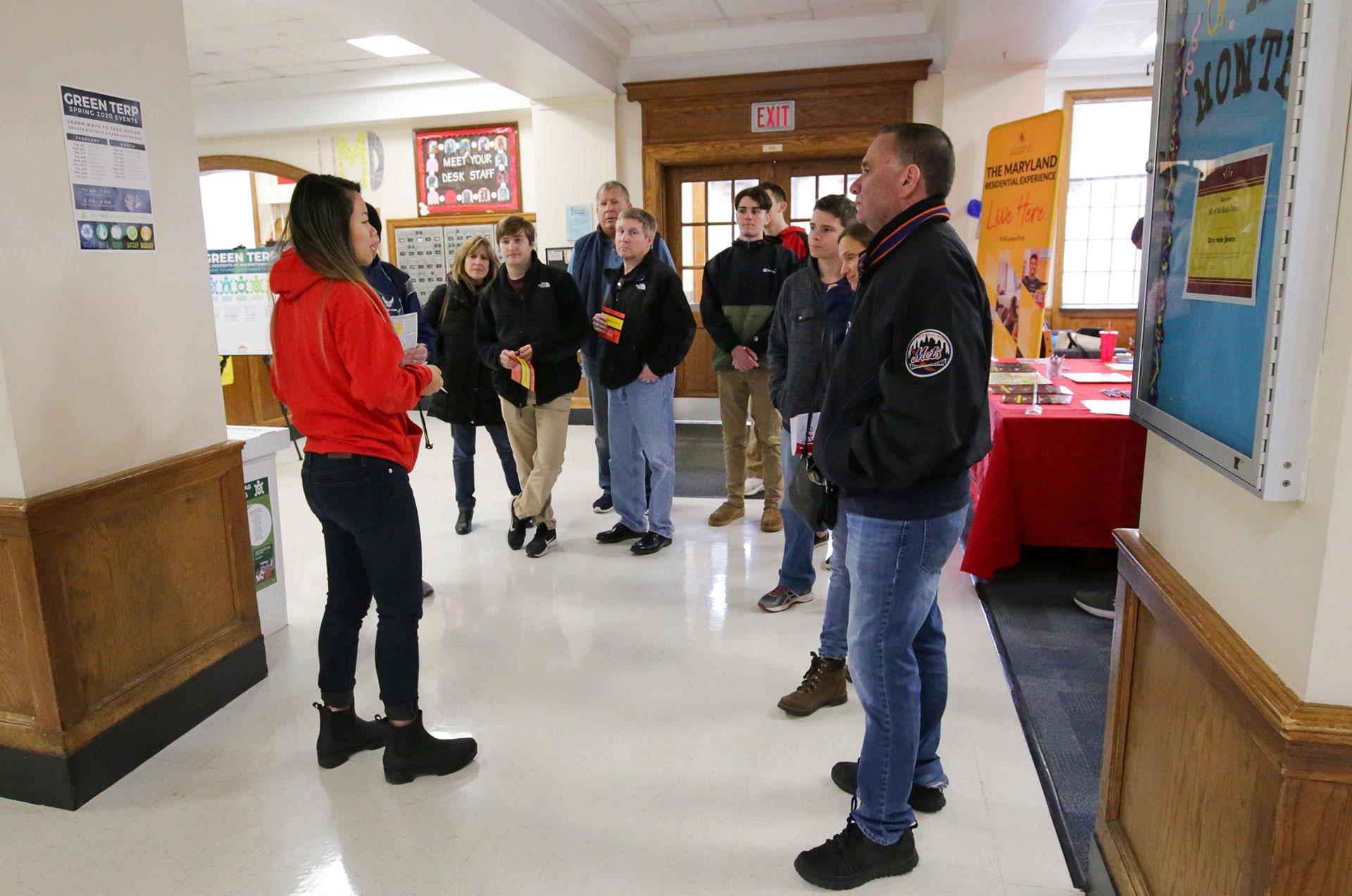 group of parents and prospective students listening to tour guide in a residence hall