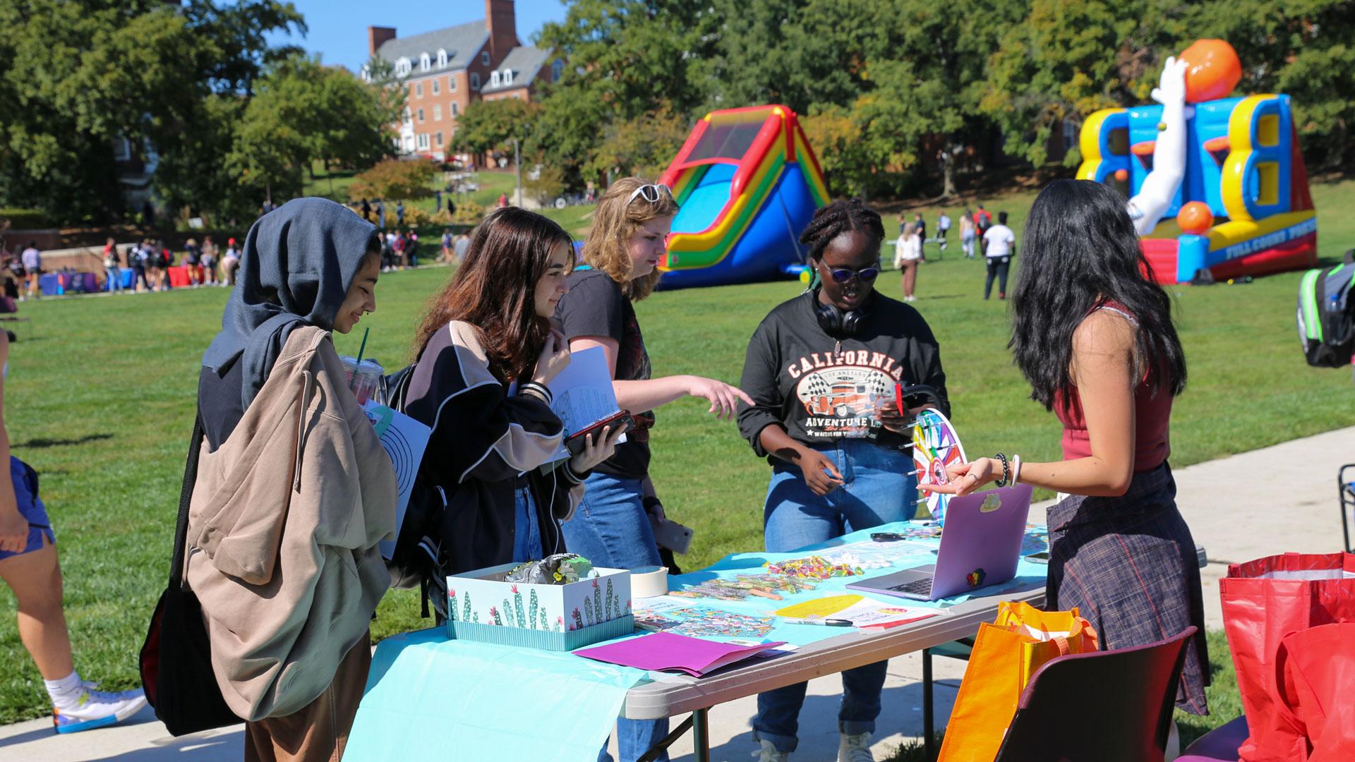 students interacting at a booth during the self care fair