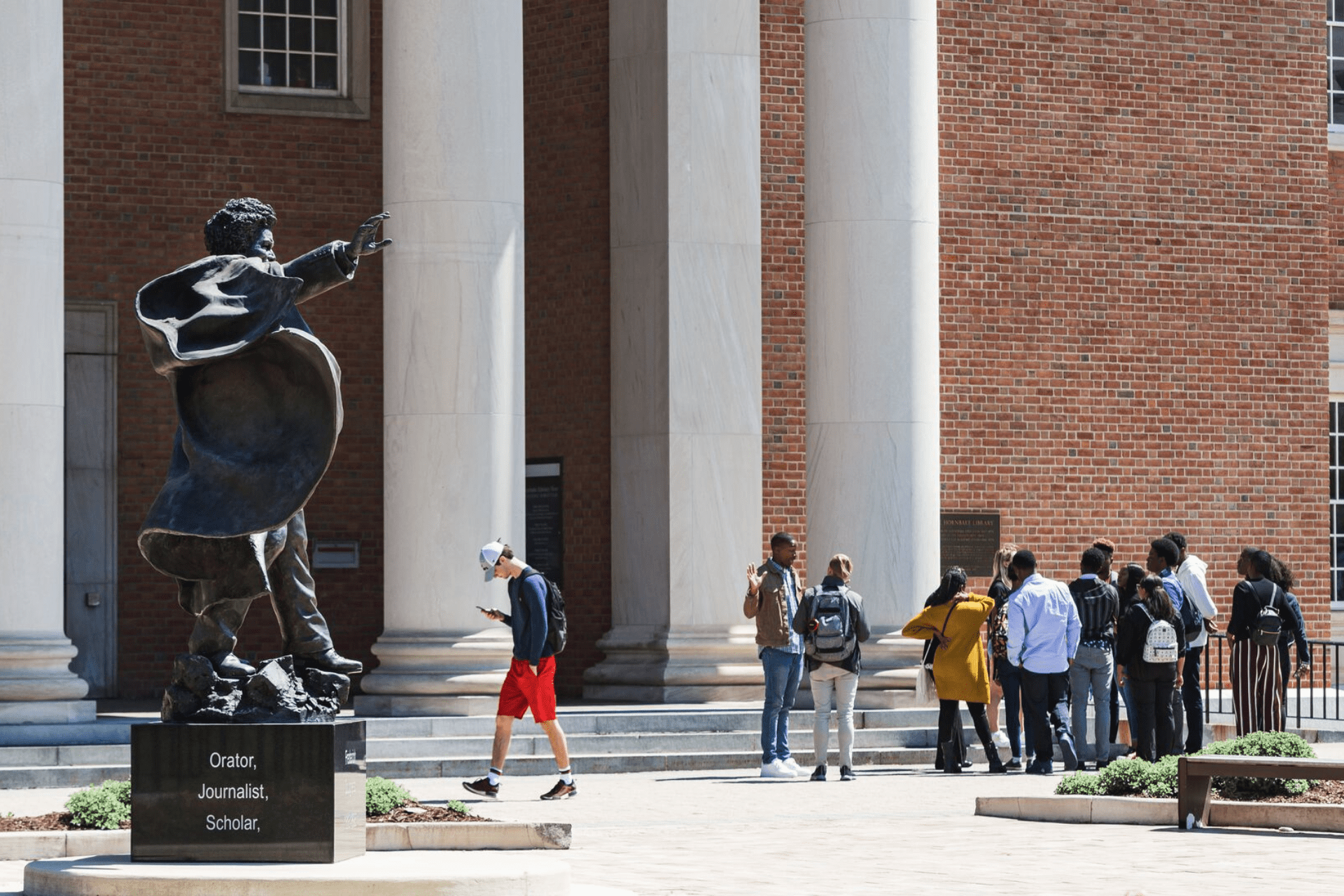 Frederick Douglass Square and Statue in front of Hornbake Library with students and people in the background