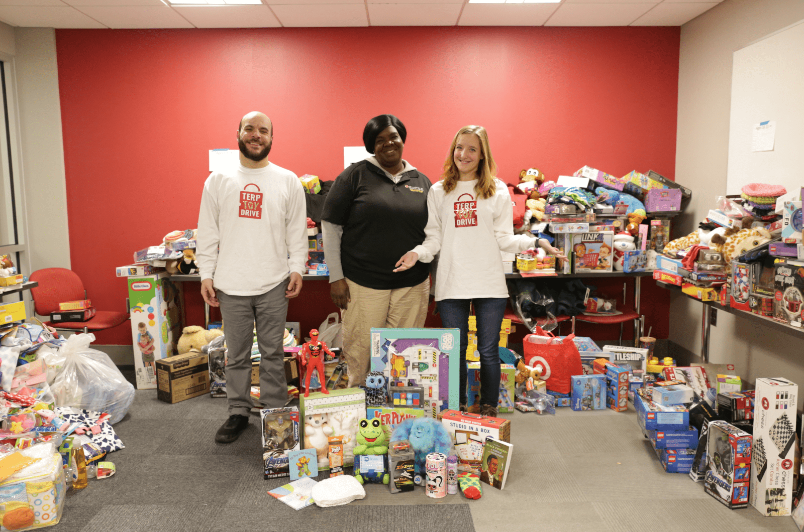 three volunteers sorting donated toys