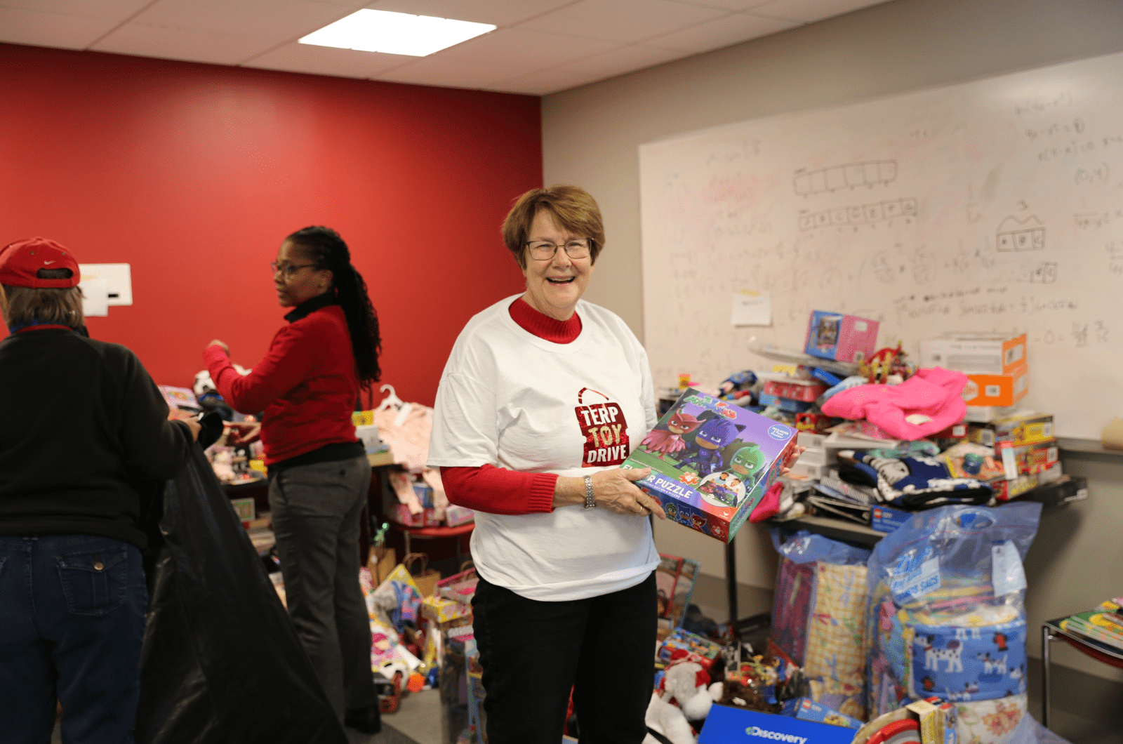 terp toy drive volunteer holding up a toy 