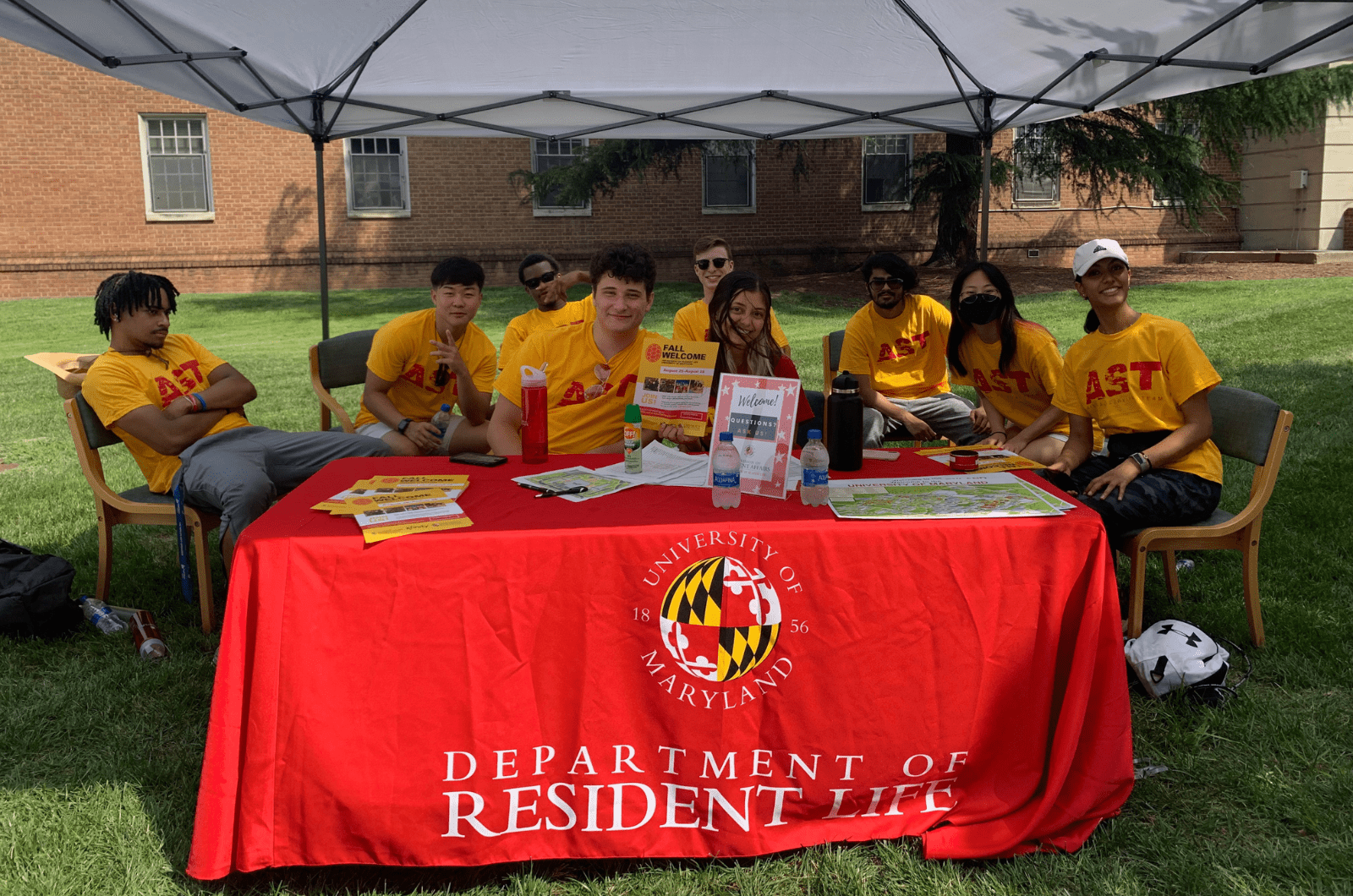 group of AST volunteers at a table outside during move-in