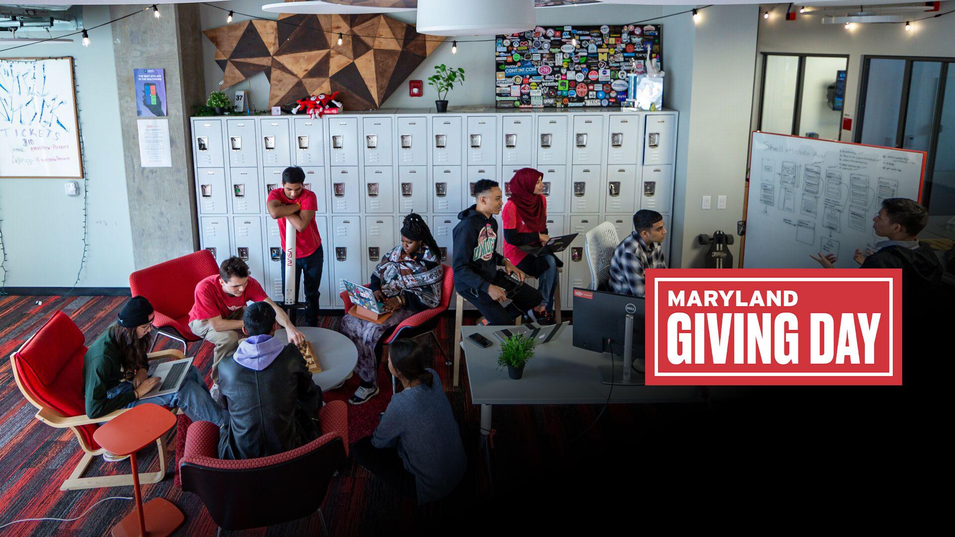 Students working in the Startup Shell suite, a student-run startup incubator and co-working space in the IDEA Factory with Giving Day logo on bottom right corner