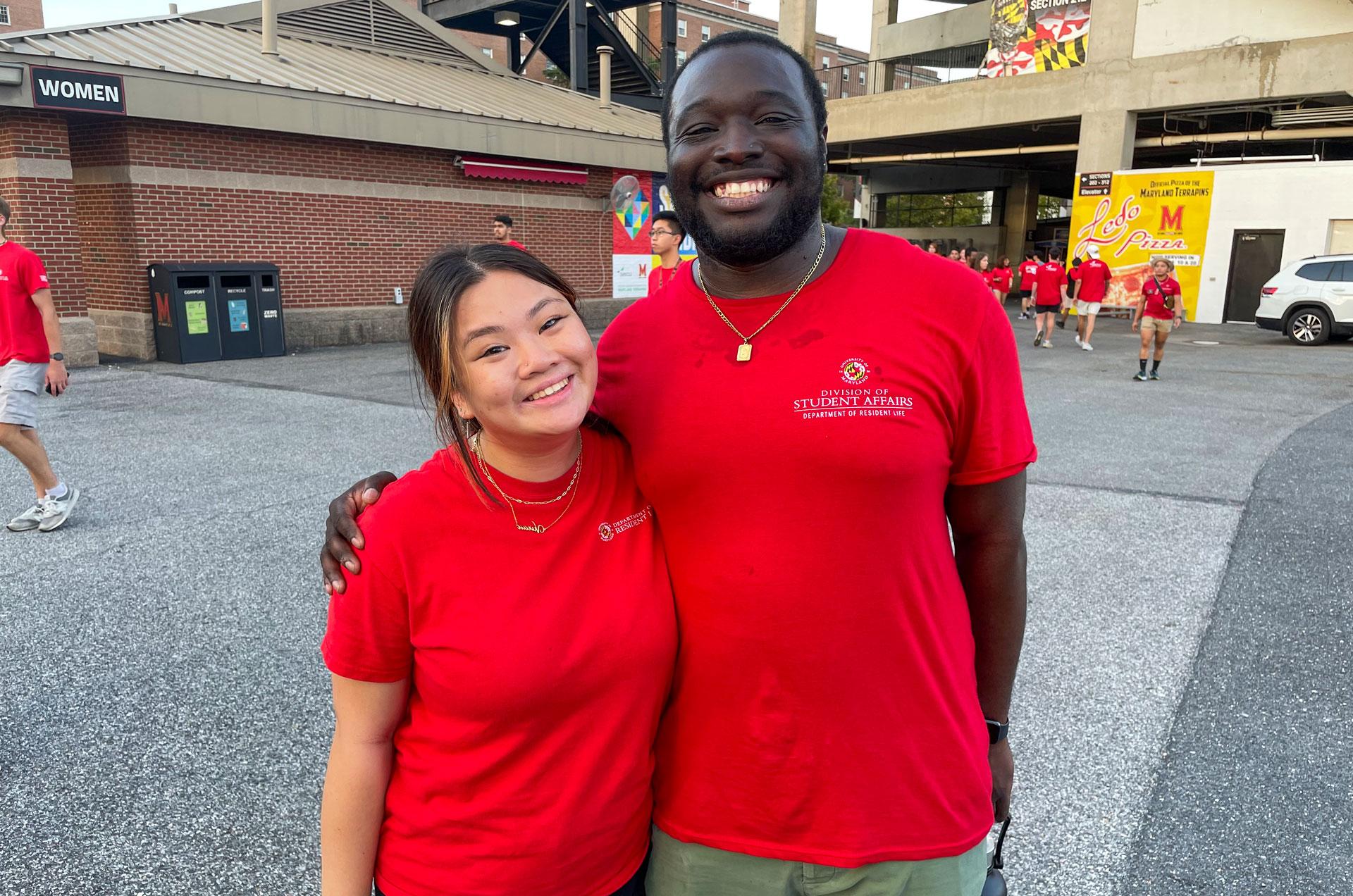 two resident life graduate assistants wearing red shirts during the Big Show event