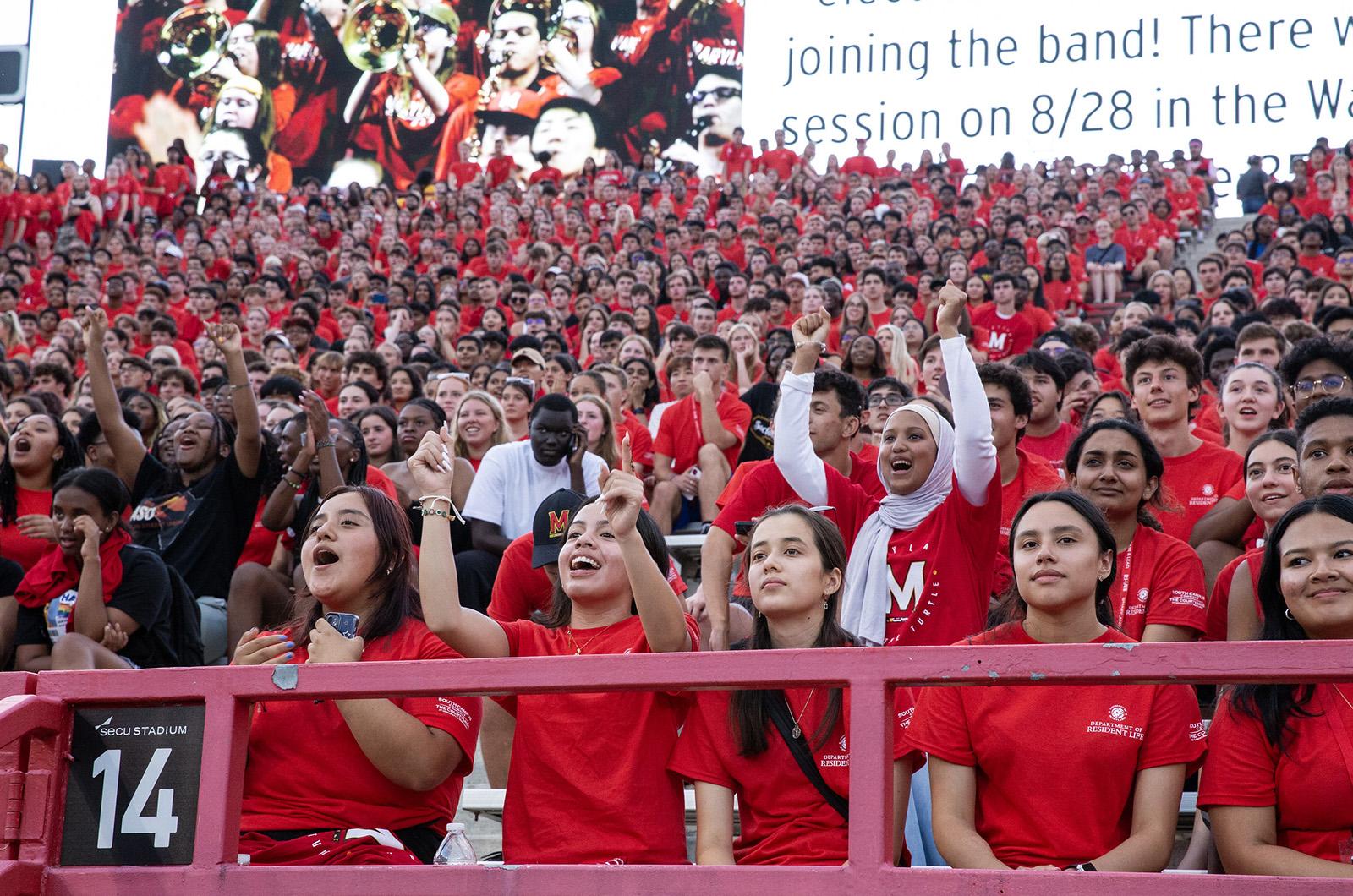 students wearing all red and cheering during Fall Welcome's Big Show