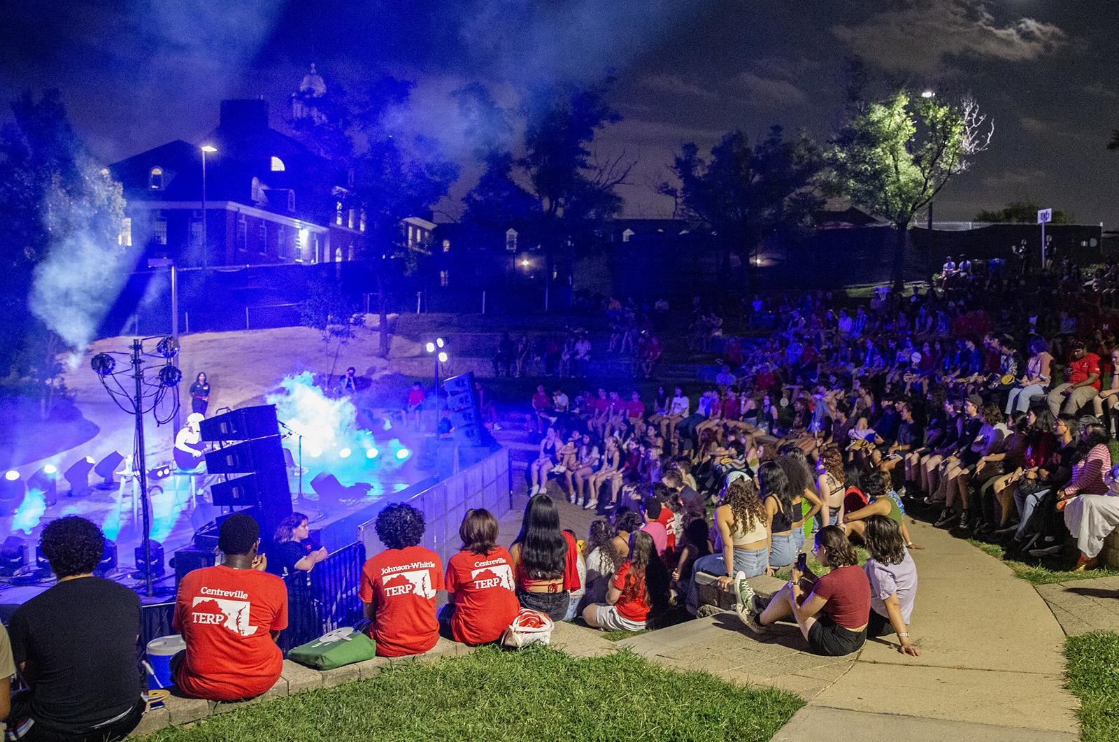 students gathered to watch a concert in amphitheater during Fall Welcome's Moonlit Music