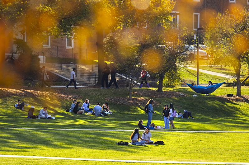 Students on McKeldin Mall framed by fall foliage.