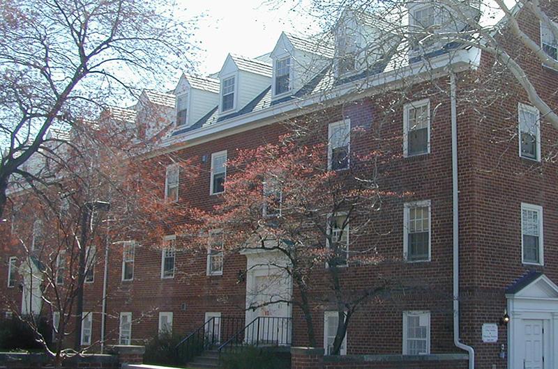 Exterior of Caroline Hall, a brick residence hall with white-trimmed windows and dormers.