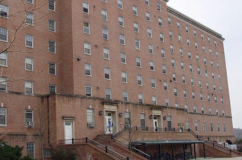 Exterior of brick Ellicott Hall with stone entryways and steps leading to two main entrances.
