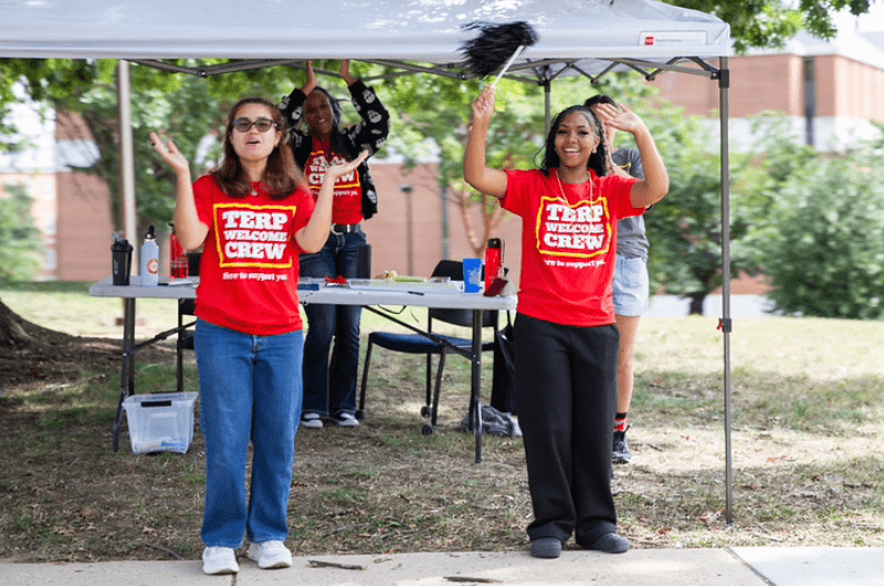 Terp Welcome Crew students waving happily