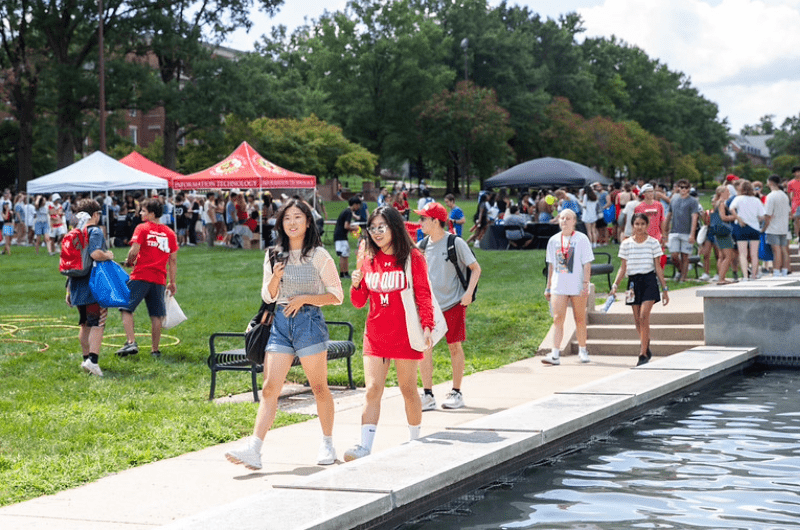 students walking near the fountain on the mall at free fest