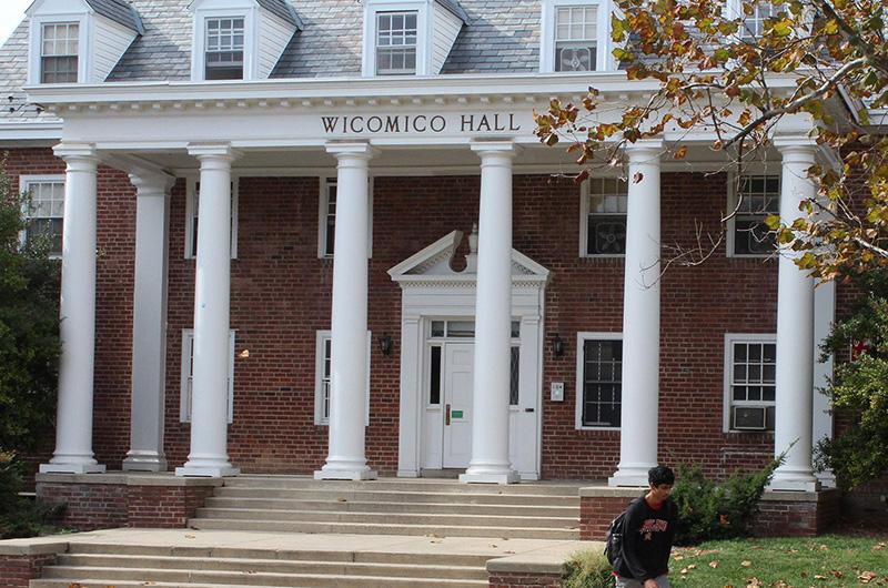 Exterior of Wicomico Hall, a brick residence hall with a white pillared entrance and steps leading to the door.